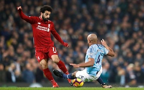 Vincent Kompany tackles Salah, resulting in a yellow card.